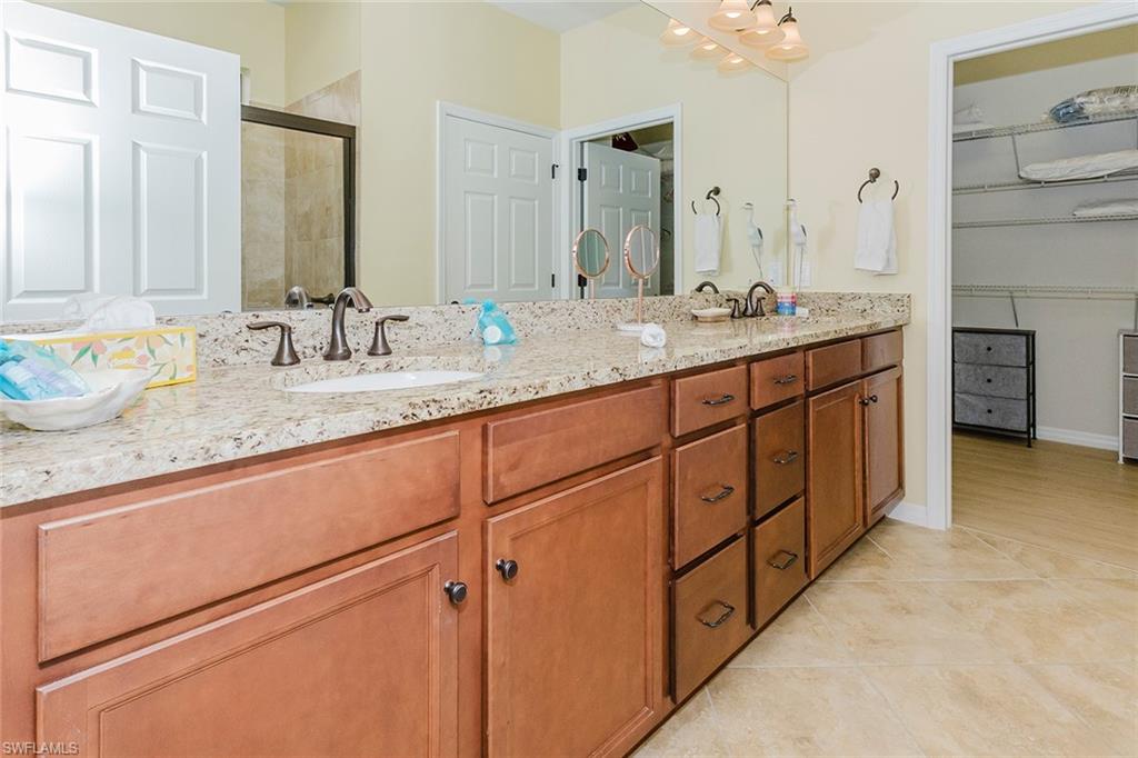 6441 Liberty Street Ave Maria, FL 34142 - Photo 26 of 48 a bathroom with a granite countertop sink and a mirror