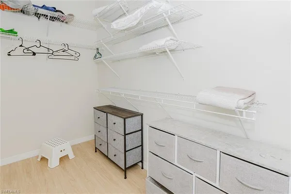 a bathroom with a granite countertop sink a mirror and a bathtub