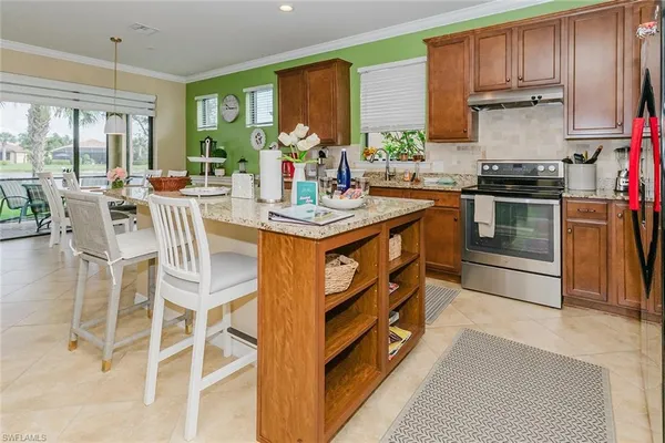 a kitchen with granite countertop lots of clutter and stainless steel appliances