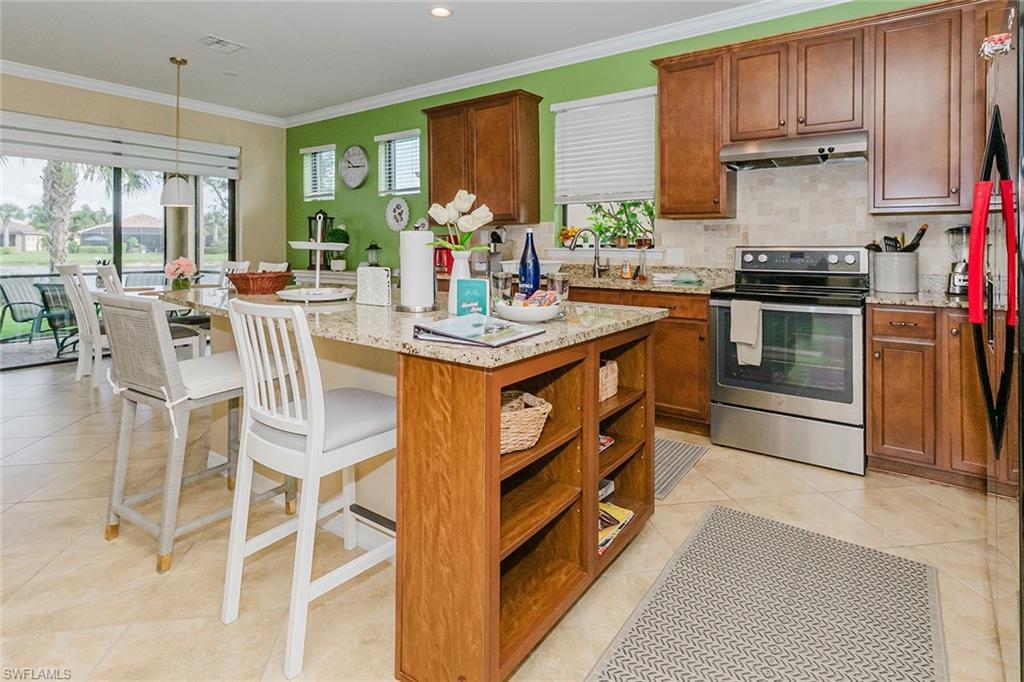 6441 Liberty Street Ave Maria, FL 34142 - Photo 30 of 48 a kitchen with stainless steel appliances granite countertop a stove and a refrigerator
