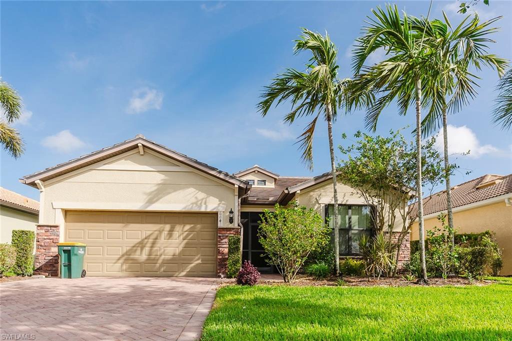 6441 Liberty Street Ave Maria, FL 34142 - Photo 3 of 48 a front view of house with yard and green space