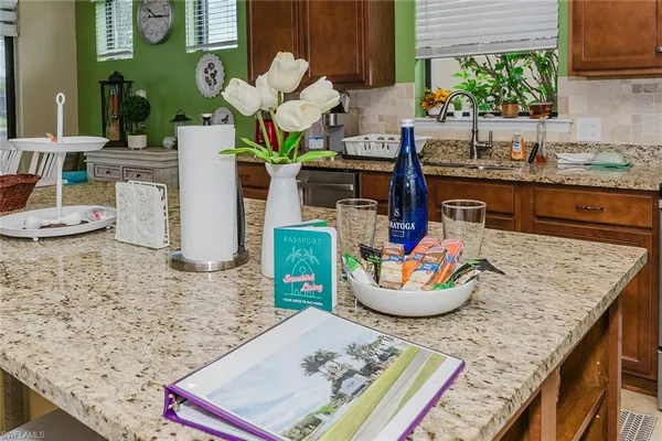 a view of kitchen island a sink wooden floor and living room view