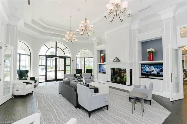 a living room with furniture and a chandelier
