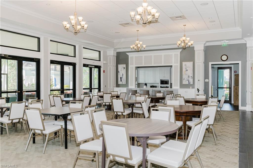 6441 Liberty Street Ave Maria, FL 34142 - Photo 40 of 48 a view of a dining room with furniture a chandelier and a chandelier