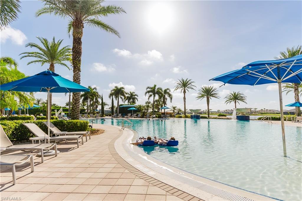6441 Liberty Street Ave Maria, FL 34142 - Photo 42 of 48 swimming pool with table and chairs under an umbrella