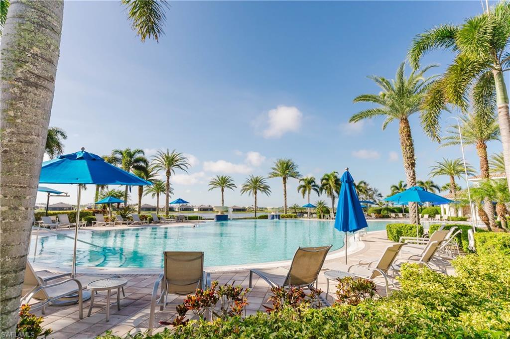 6441 Liberty Street Ave Maria, FL 34142 - Photo 43 of 48 a view of a lake with a table and chairs