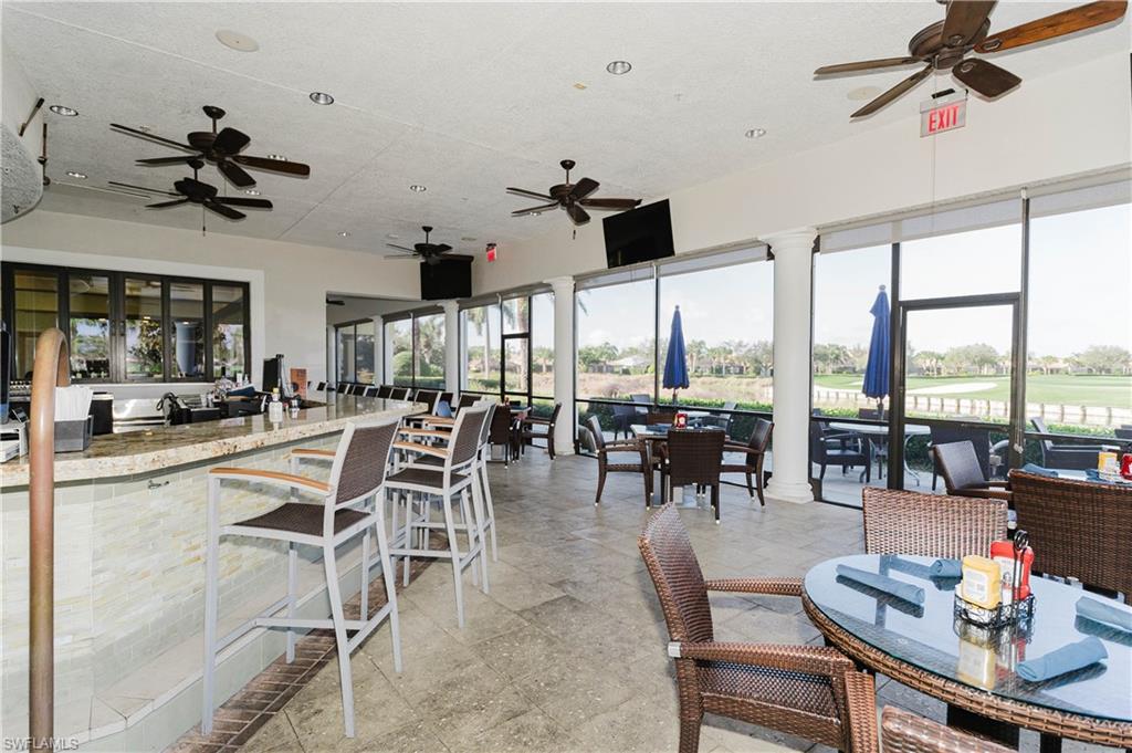 6441 Liberty Street Ave Maria, FL 34142 - Photo 44 of 48 a dining room with furniture water view and a floor to ceiling window