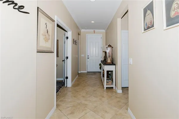 a view of a hallway with entryway and furniture