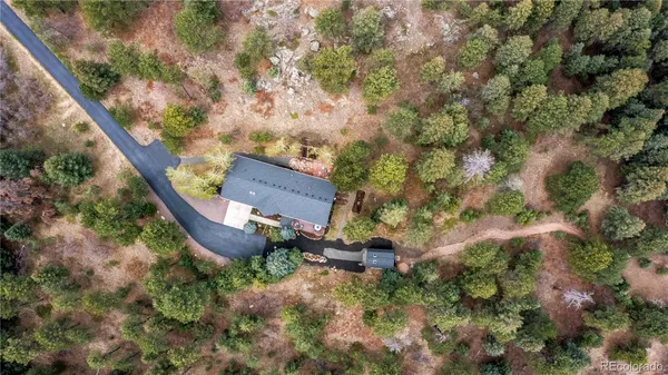 an aerial view of a house with a yard