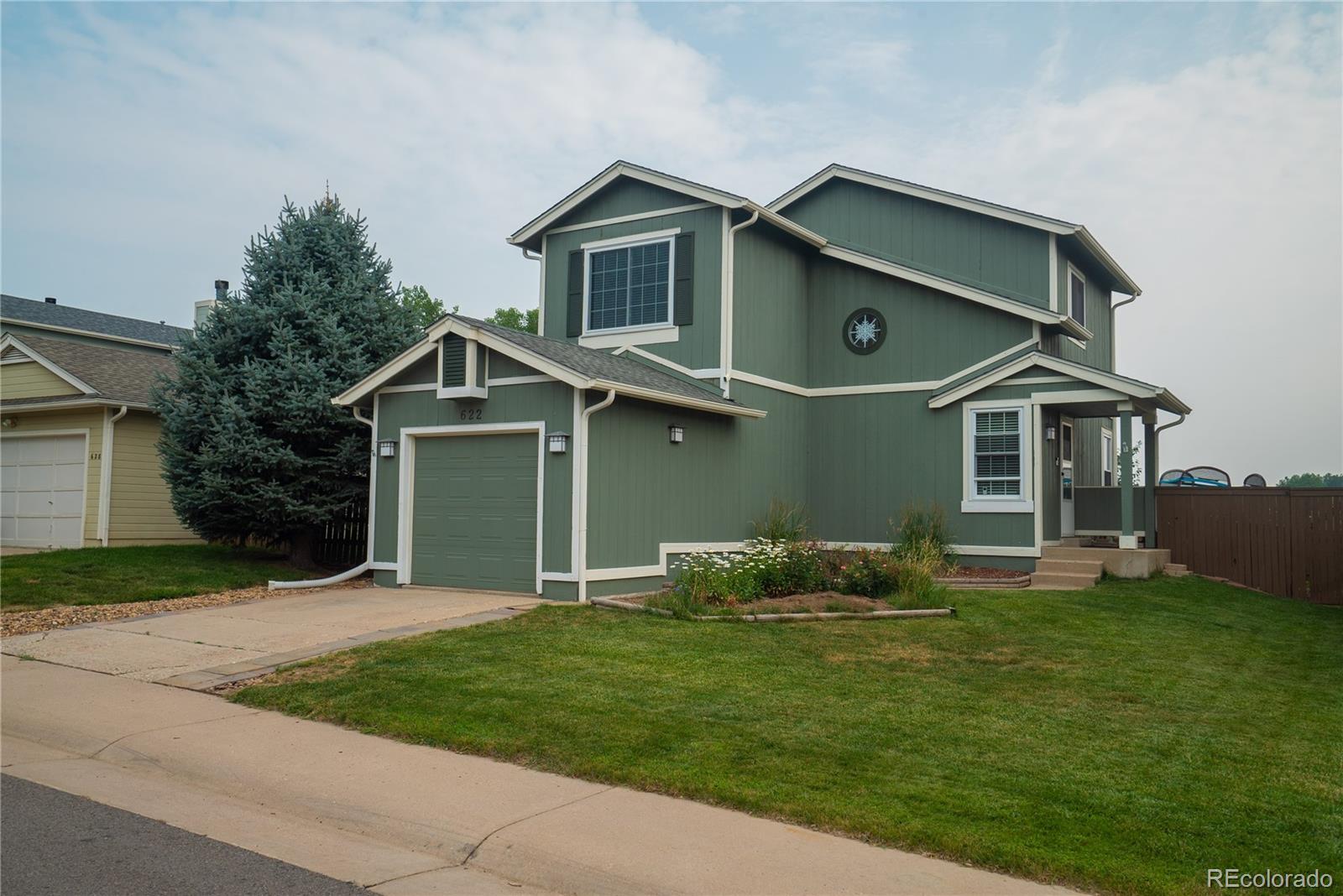 622 Longfellow Lane Highlands Ranch, CO 80126 - Photo 1 of 24 front view of a house with a yard