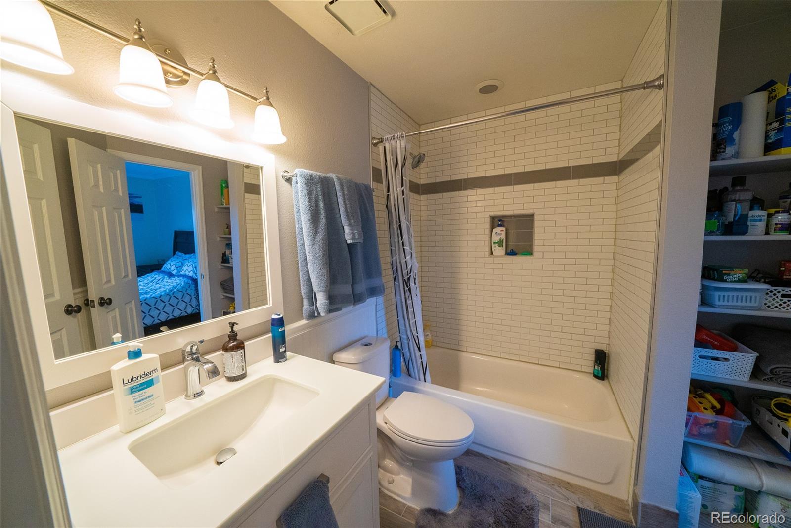 622 Longfellow Lane Highlands Ranch, CO 80126 - Photo 18 of 24 a bathroom with a sink a toilet and shower