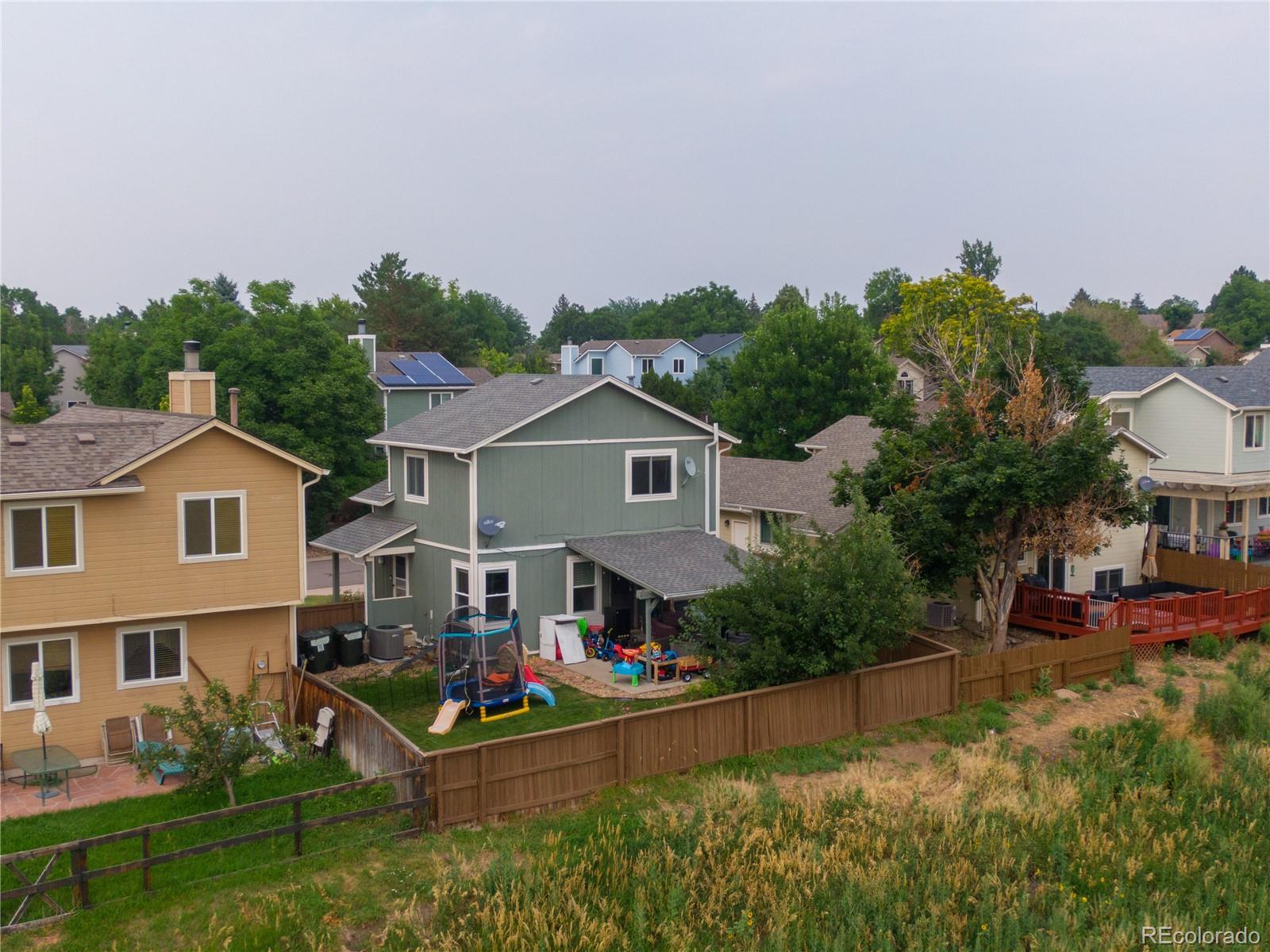 622 Longfellow Lane Highlands Ranch, CO 80126 - Photo 4 of 24 a aerial view of a house with a big yard and potted plants in front of the house