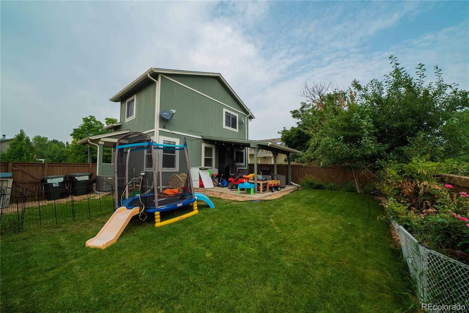 622 Longfellow Lane Highlands Ranch, CO 80126 - Photo 7 of 24 a view of a chair and table in backyard of the house