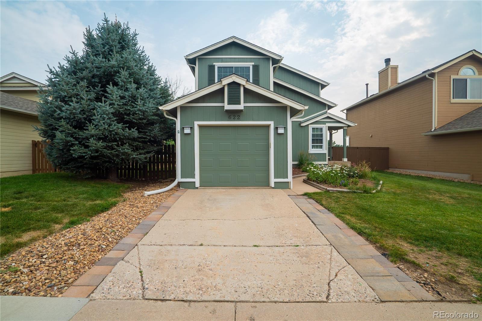 622 Longfellow Lane Highlands Ranch, CO 80126 - Photo 8 of 24 a front view of a house with a yard and garage
