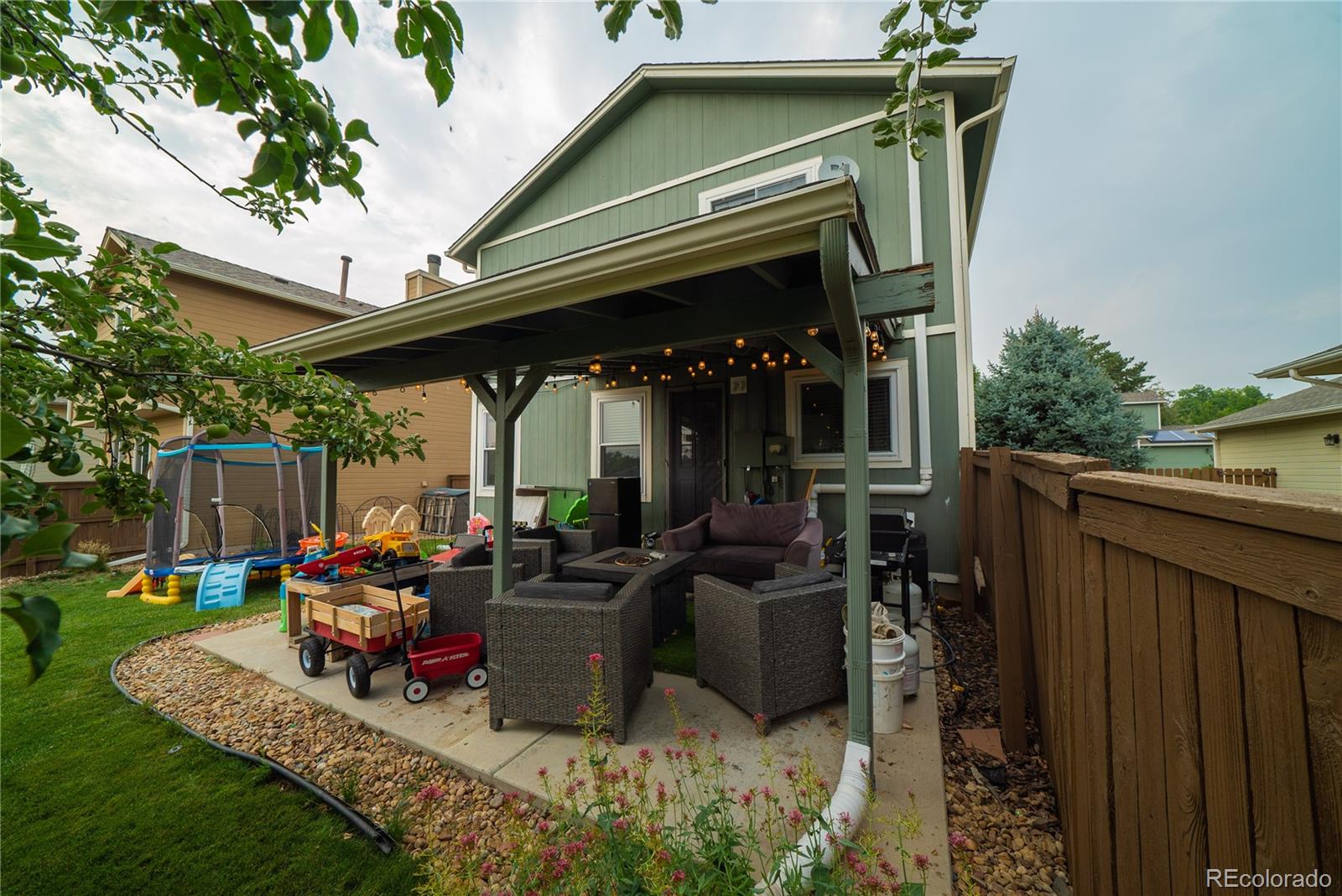 622 Longfellow Lane Highlands Ranch, CO 80126 - Photo 9 of 24 a view of a patio with table and chairs potted plants and a barbeque