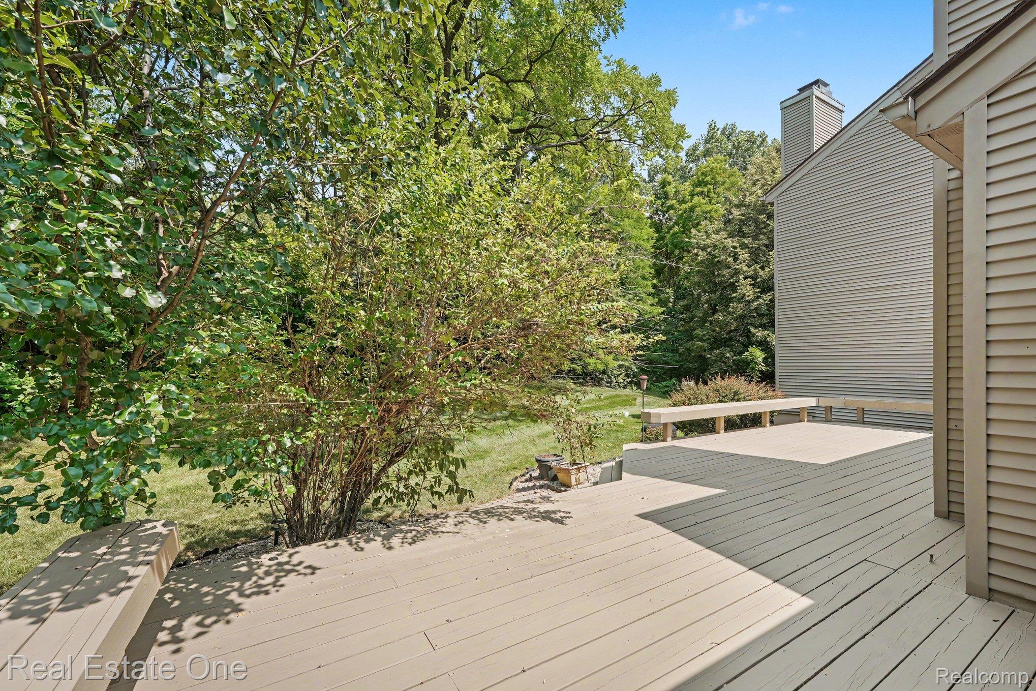 701 Charing Court Rochester, MI 48307 - Photo 26 of 29 Spacious outdoor deck with built-in bench seating, wood-finish decking, and ample natural light