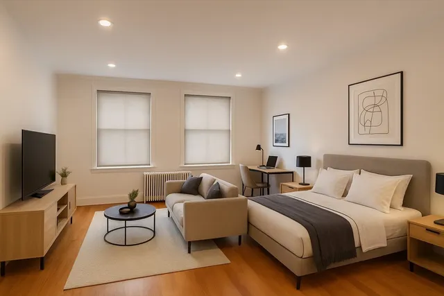 a spacious bedroom with two beds and a flat screen television