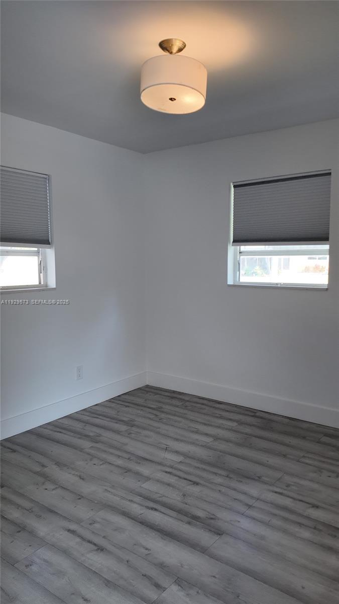 2100 North 57th Way Hollywood, FL 33021 - Photo 21 of 47 an empty room with wooden floor and windows