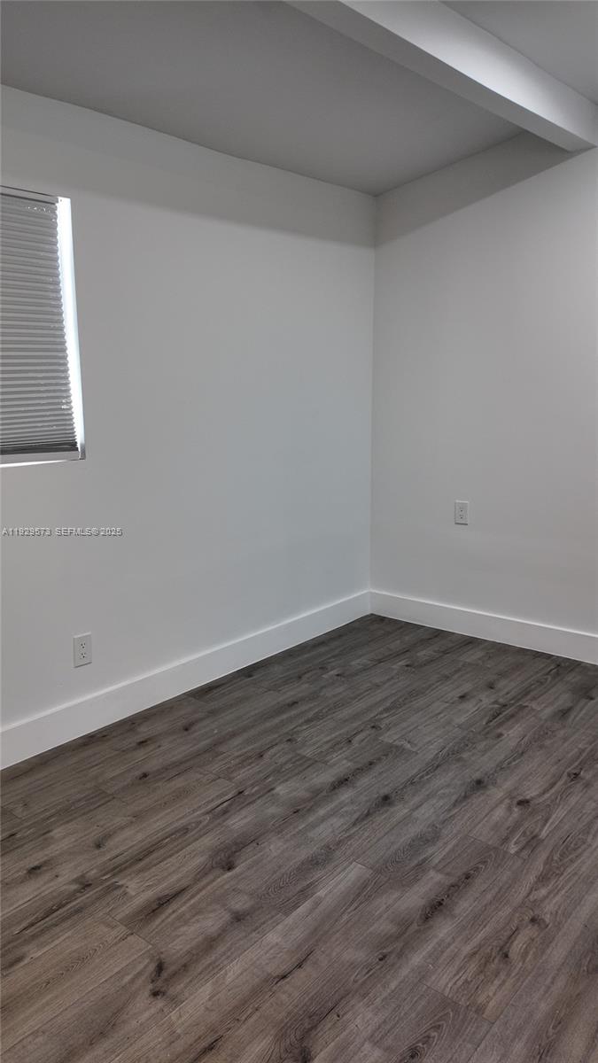 2100 North 57th Way Hollywood, FL 33021 - Photo 26 of 47 a view of an empty room with wooden floor and a window