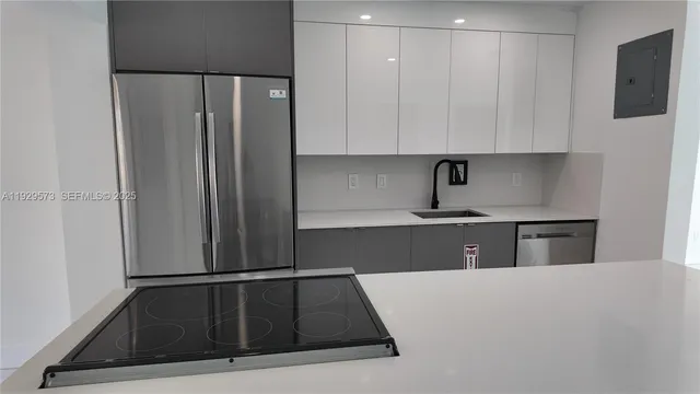 a kitchen with a refrigerator and a sink