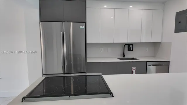 a kitchen with a refrigerator and cabinets