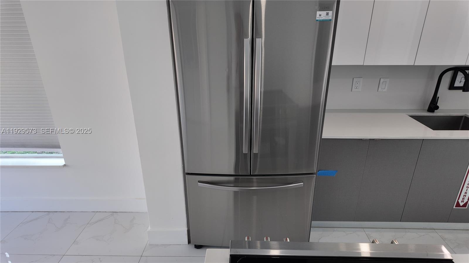 2100 North 57th Way Hollywood, FL 33021 - Photo 32 of 47 a kitchen with a refrigerator and cabinets