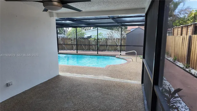 a view of a backyard with a swimming pool