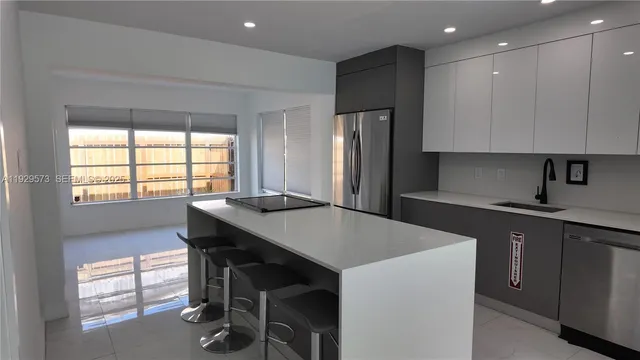 a kitchen with a table chairs sink and cabinets
