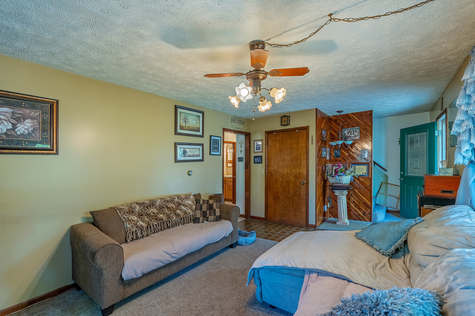 902 Warren Street Chenoa, IL 61726 - Photo 17 of 36 a living room with furniture ceiling fan and a rug