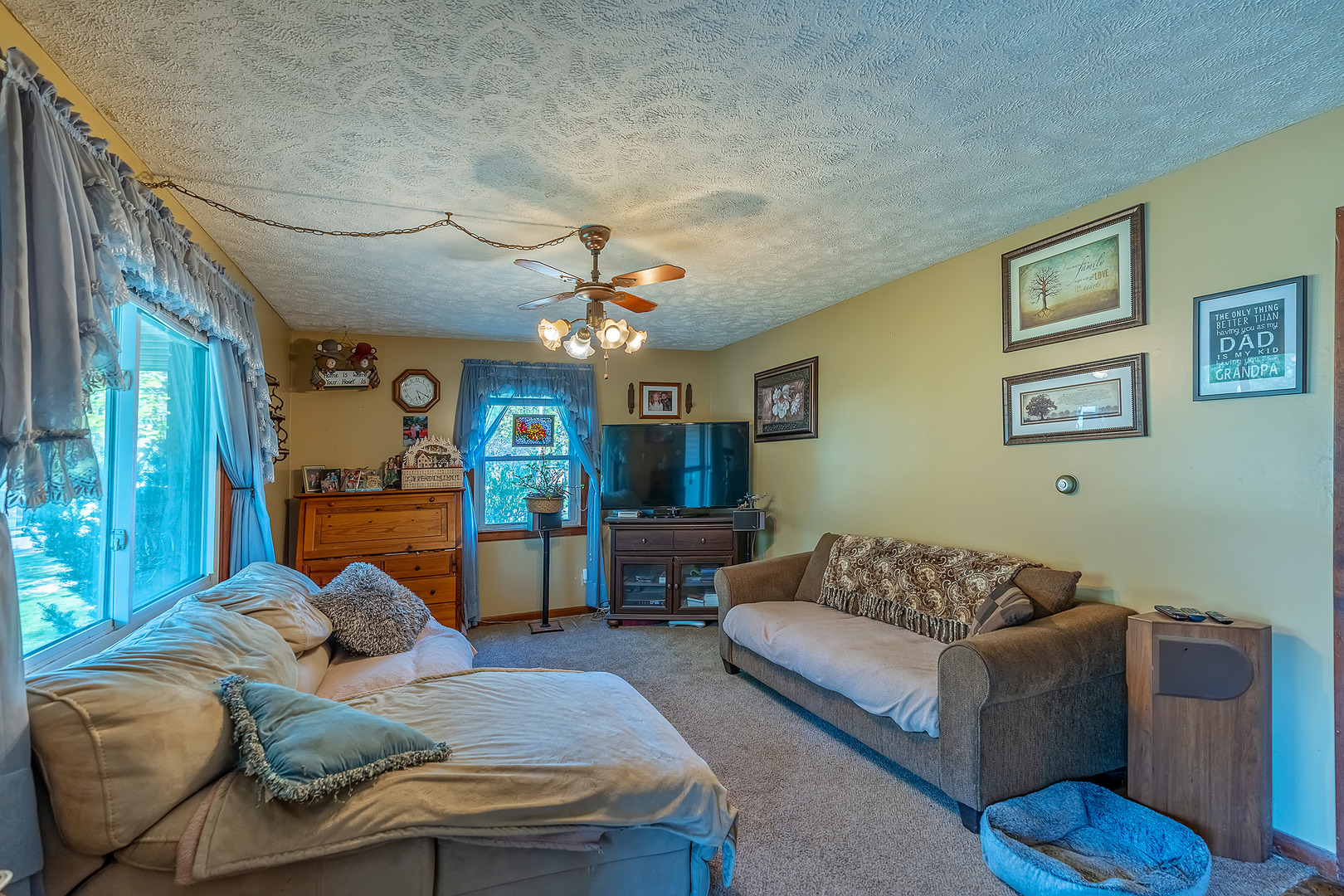 902 Warren Street Chenoa, IL 61726 - Photo 18 of 36 a living room with furniture and a chandelier