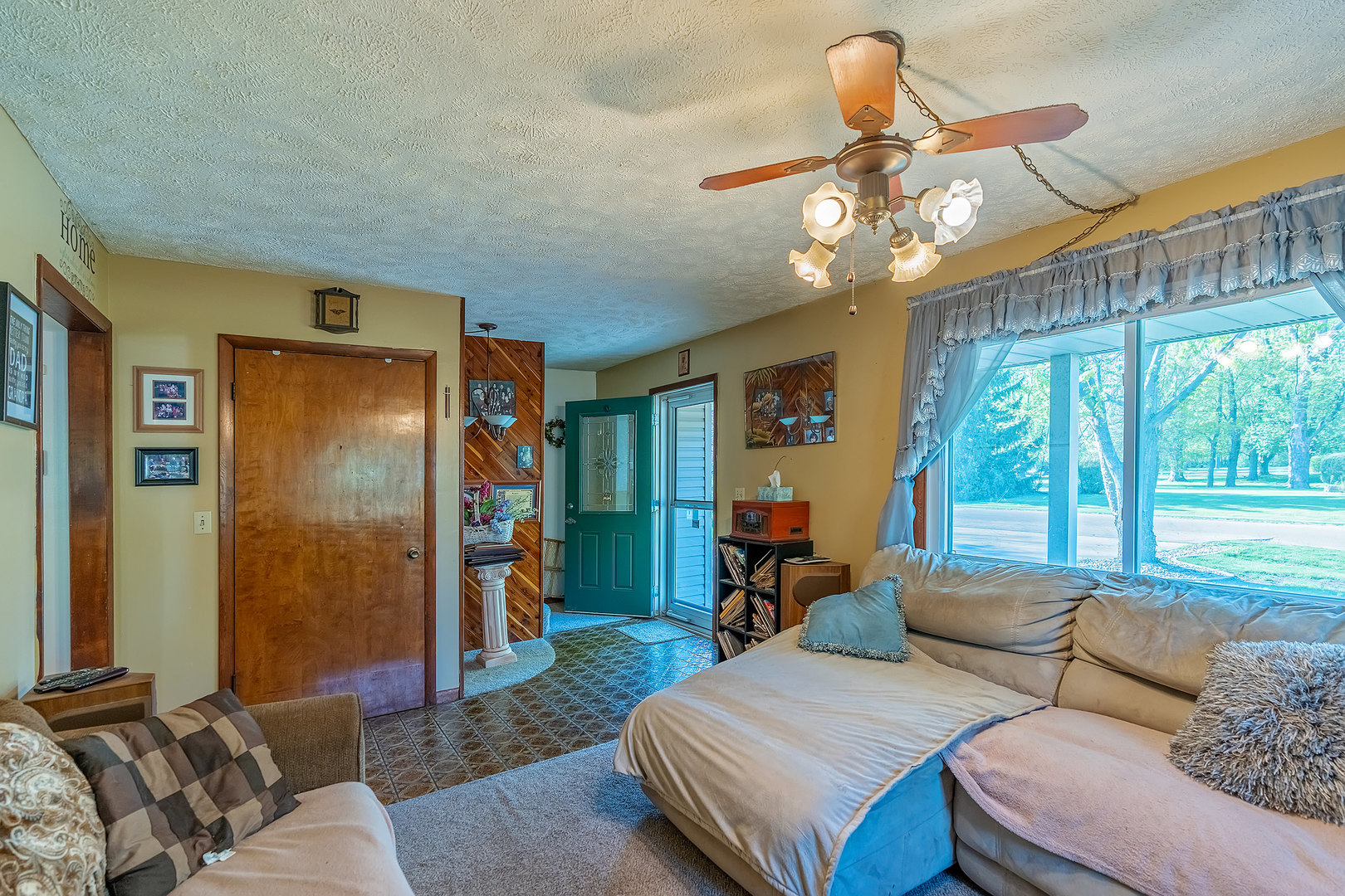 902 Warren Street Chenoa, IL 61726 - Photo 19 of 36 a living room with furniture and a chandelier