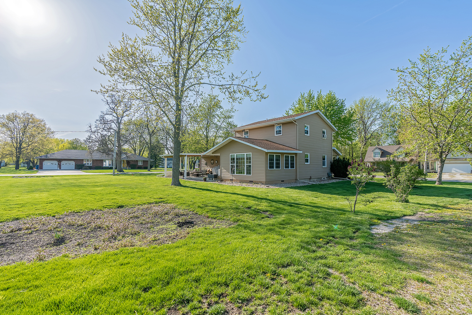 902 Warren Street Chenoa, IL 61726 - Photo 2 of 36 a front view of a house with a yard table and chairs