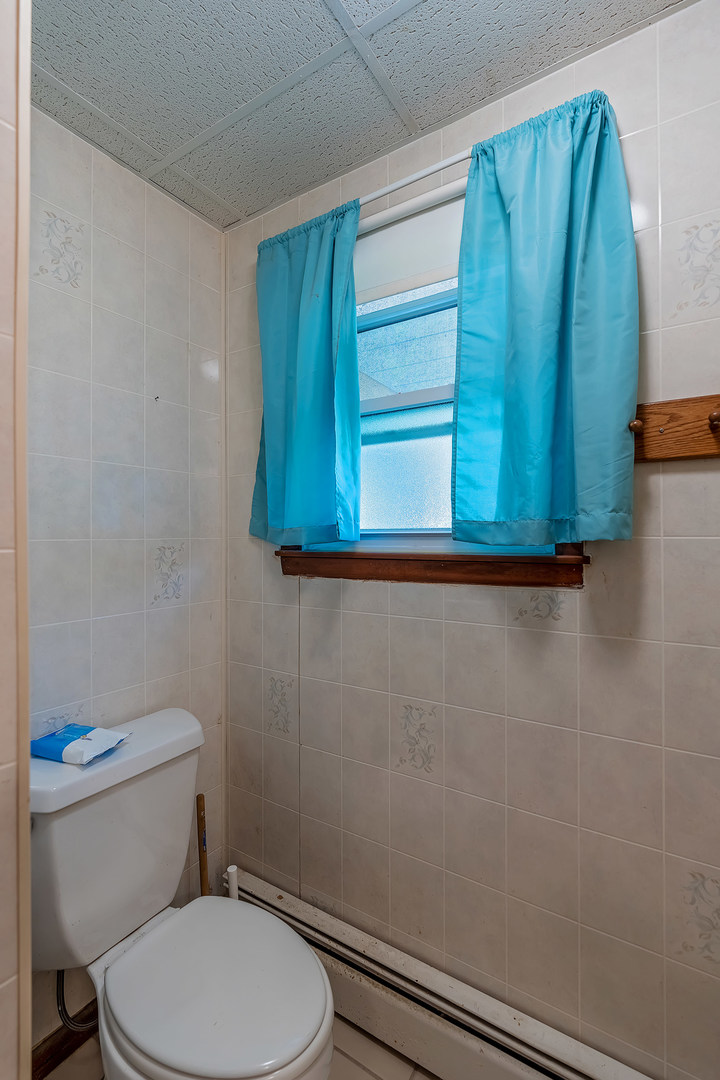 902 Warren Street Chenoa, IL 61726 - Photo 25 of 36 a white toilet sitting next to a shower