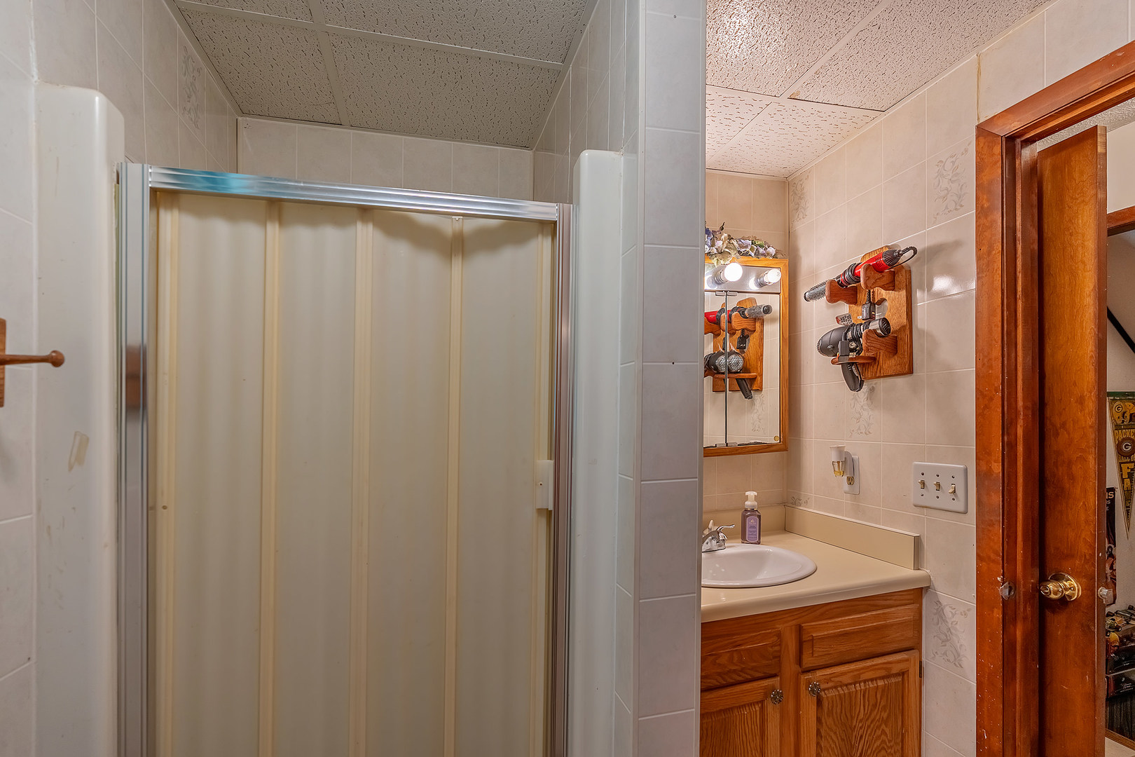 902 Warren Street Chenoa, IL 61726 - Photo 26 of 36 a bathroom with a sink and mirror with shower