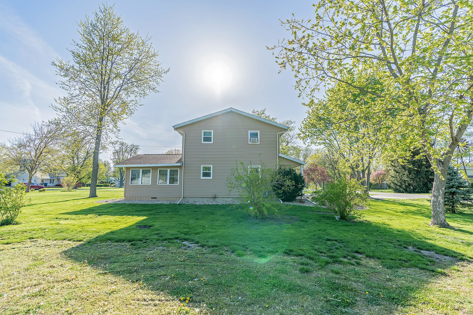 902 Warren Street Chenoa, IL 61726 - Photo 3 of 36 a view of a big house with a big yard and large trees