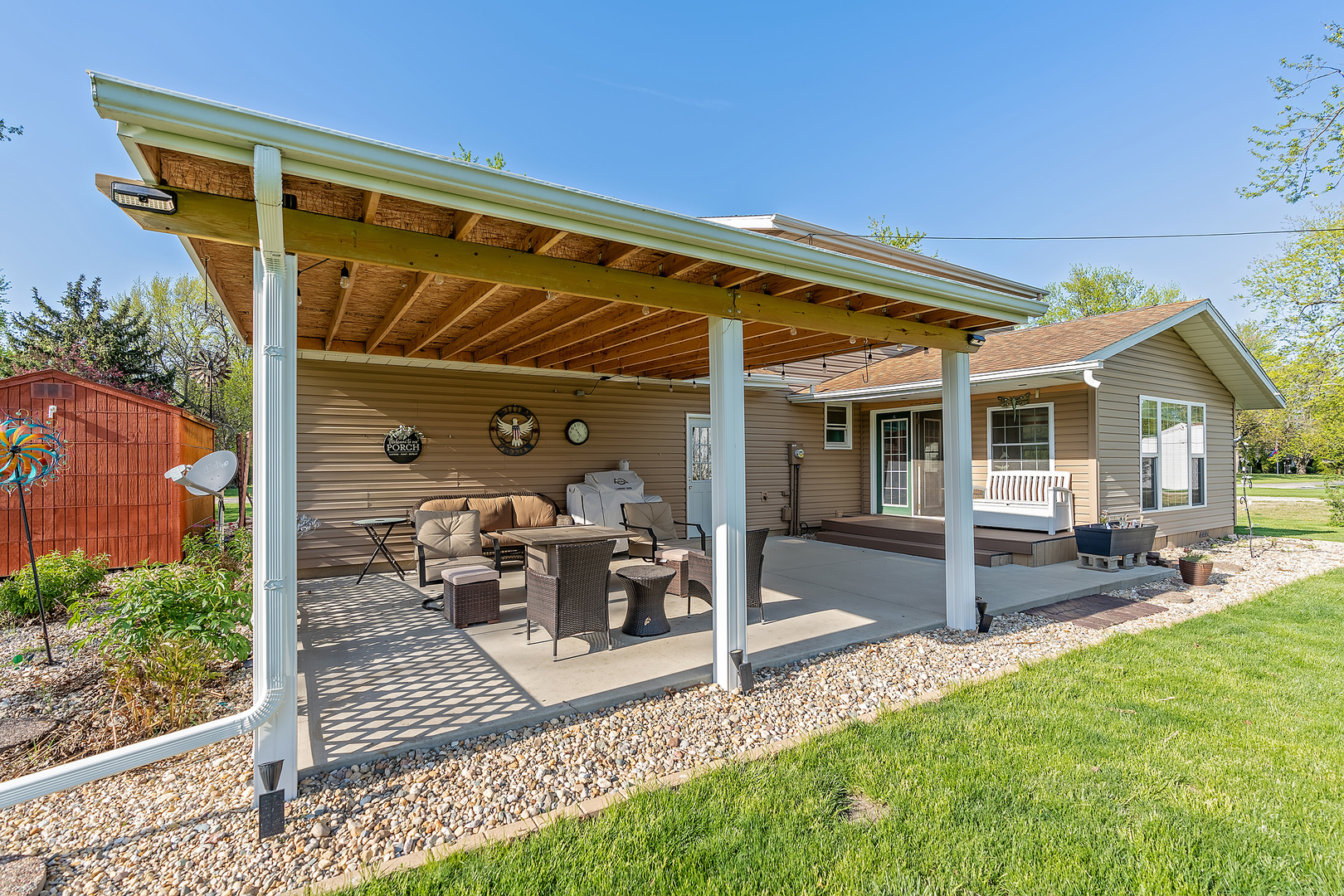 902 Warren Street Chenoa, IL 61726 - Photo 8 of 36 a view of a house with backyard sitting area and garden