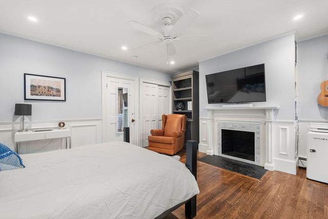 a spacious bedroom with a bed and a flat screen tv