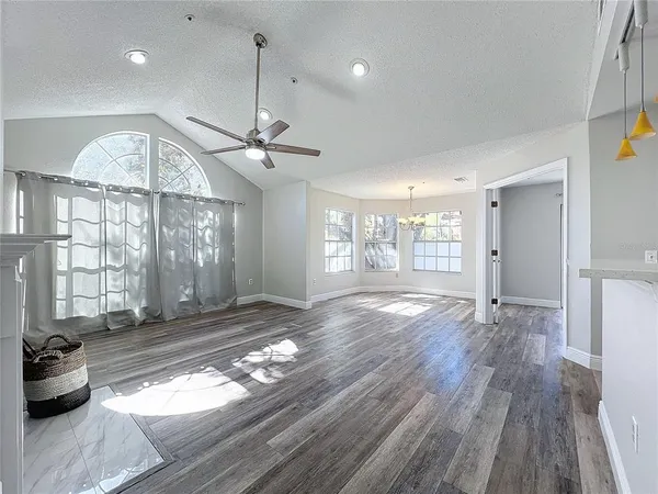 a view of a kitchen with a hallway wooden floor and a fireplace