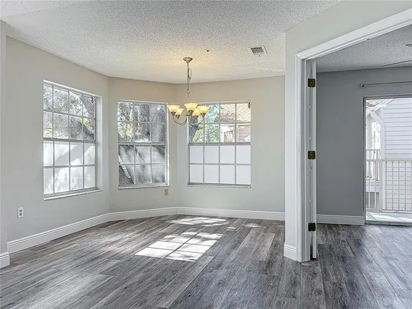 a kitchen with stainless steel appliances granite countertop a sink a stove and a wooden floors