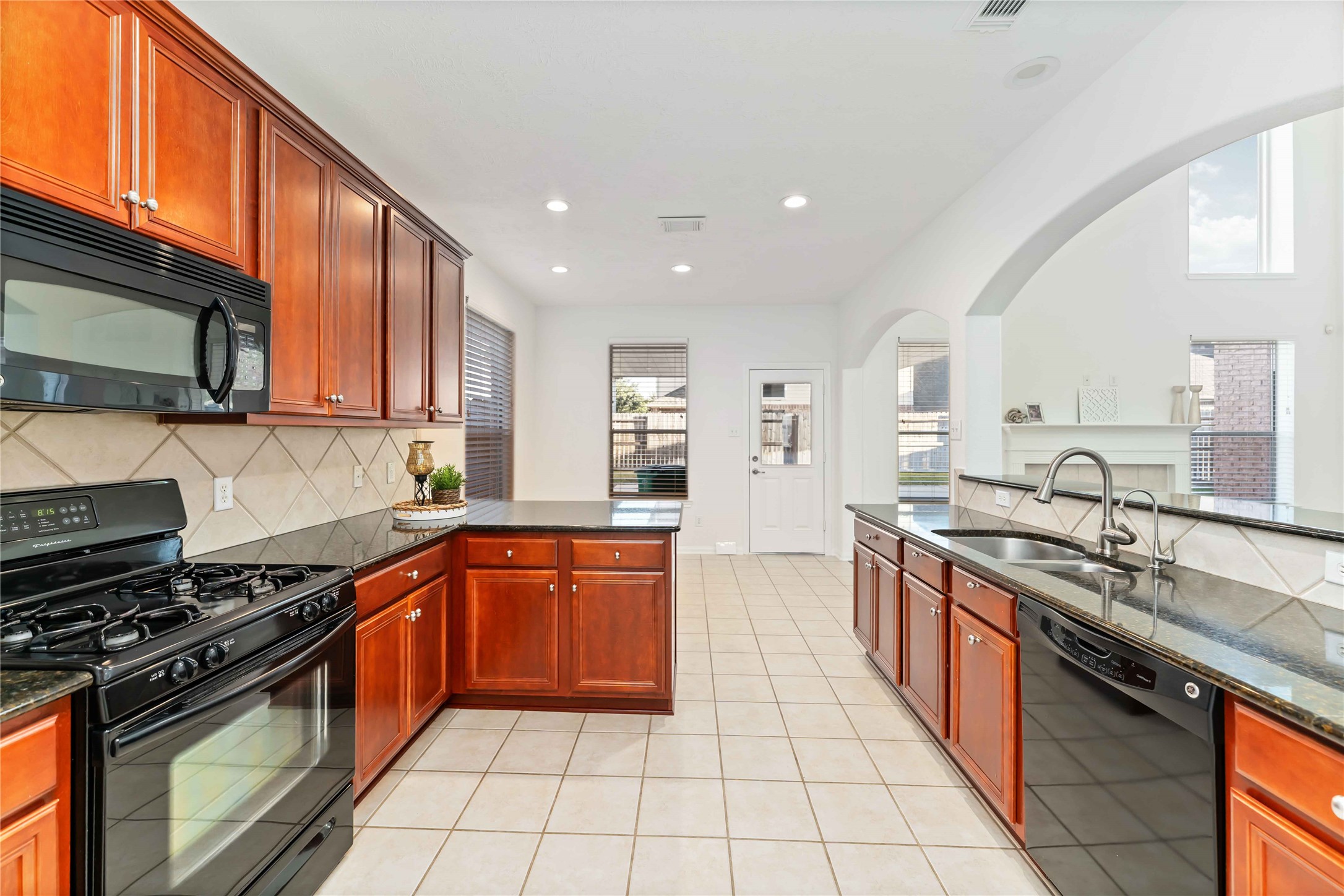 7226 VORGEN Court Spring, TX 77379 - Photo 12 of 43 a large kitchen with stainless steel appliances granite countertop a stove top oven a sink dishwasher and granite countertops