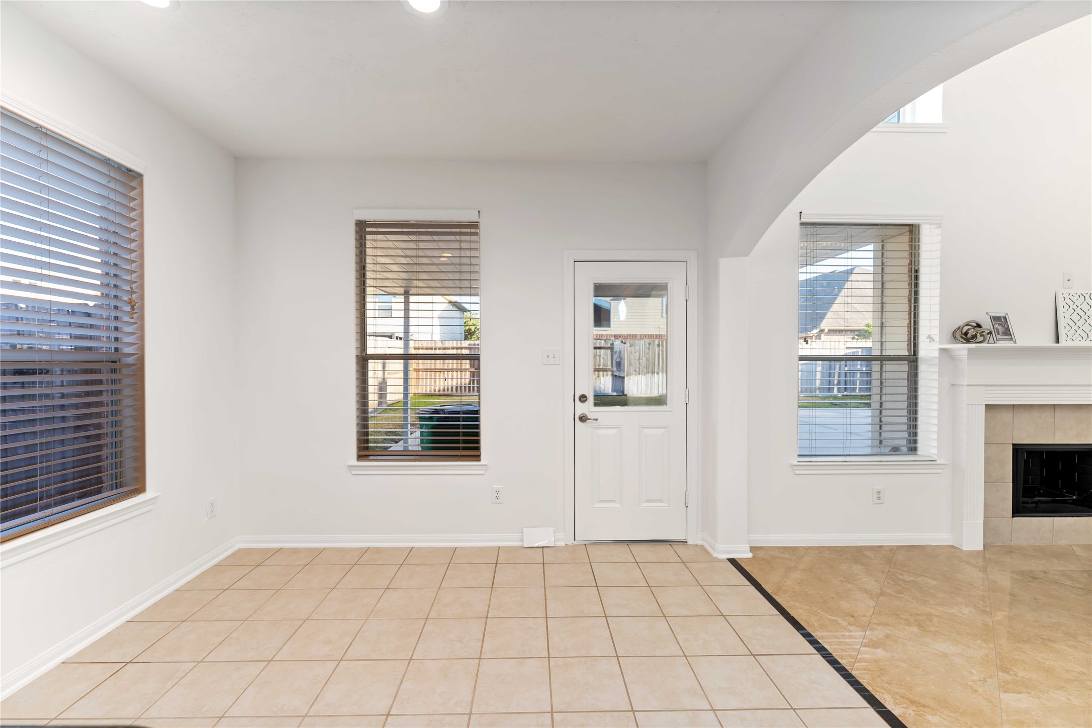 7226 VORGEN Court Spring, TX 77379 - Photo 13 of 43 a view of an empty room with a fireplace and a window