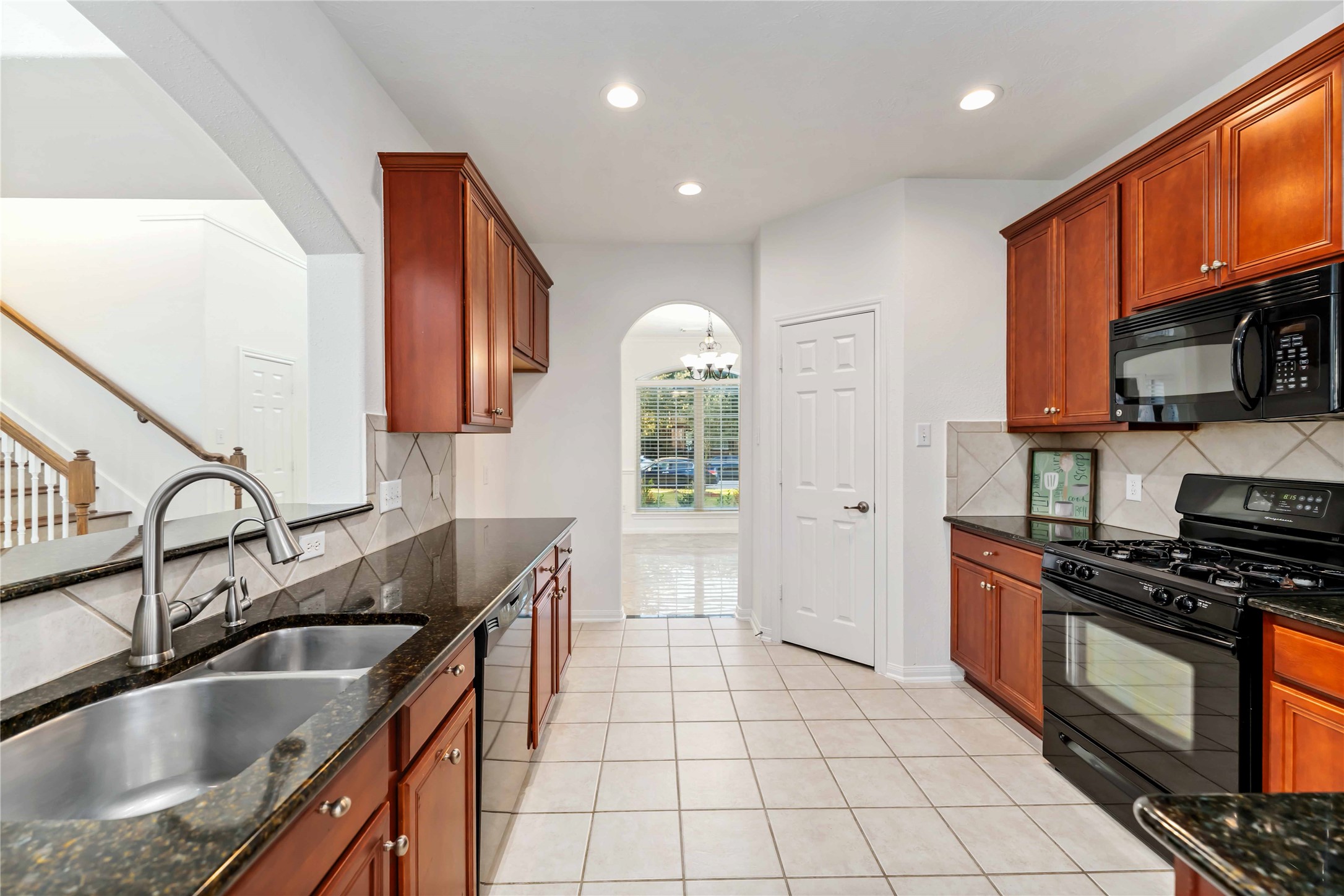7226 VORGEN Court Spring, TX 77379 - Photo 14 of 43 a kitchen with granite countertop a sink stainless steel appliances and cabinets