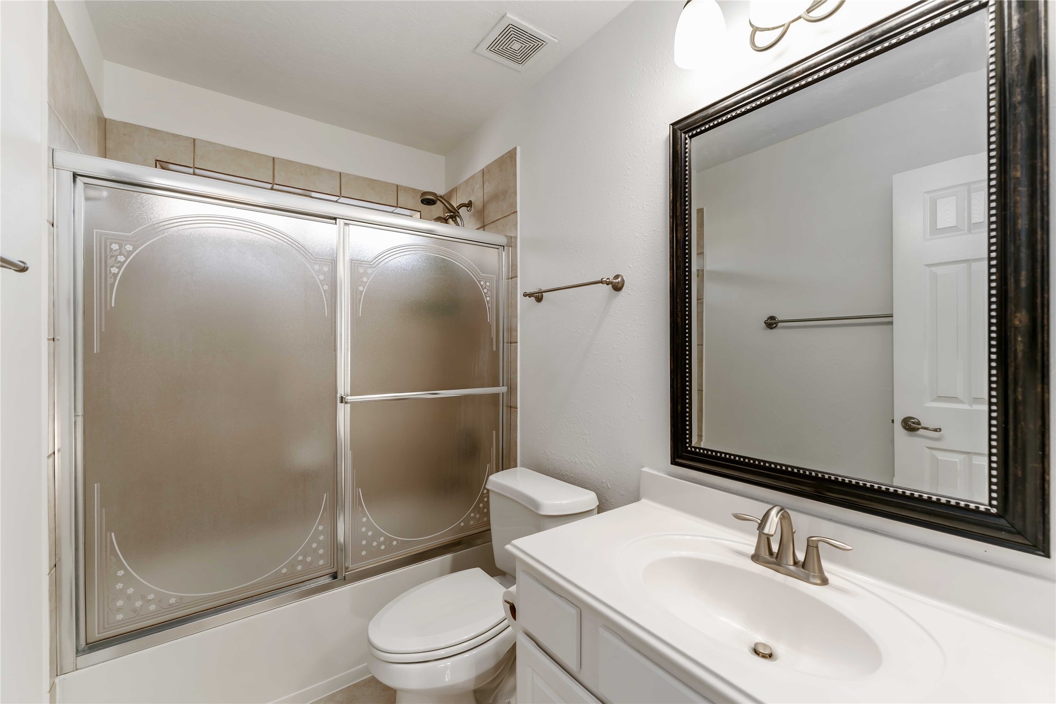 7226 VORGEN Court Spring, TX 77379 - Photo 34 of 43 a bathroom with a shower sink vanity mirror and toilet