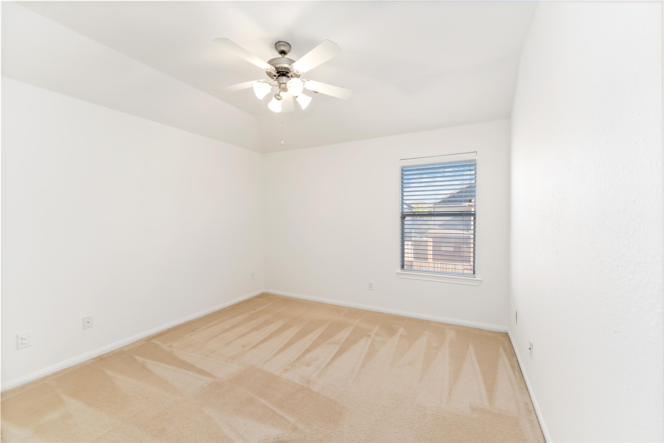 7226 VORGEN Court Spring, TX 77379 - Photo 35 of 43 an empty room with a chandelier fan and windows