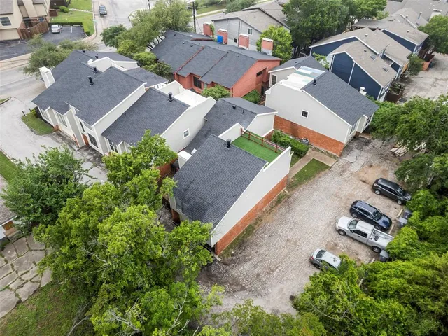 an aerial view of multiple houses with yard