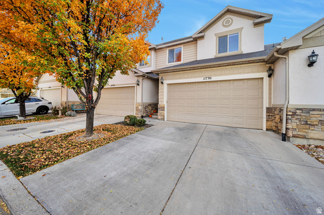 11730 South Shadow Lane Draper, UT 84020 - Photo 1 of 24 View of front of home with stone siding, driveway, an attached garage, and stucco siding
