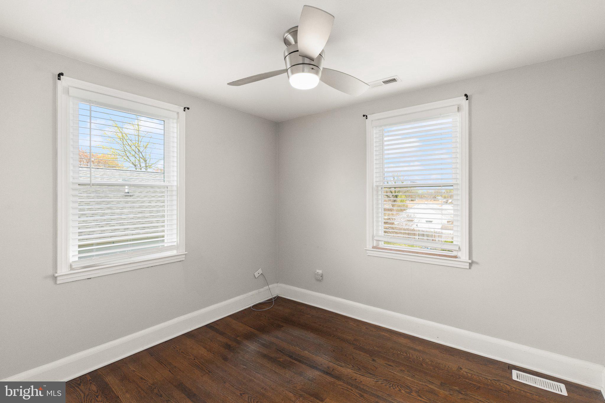 7512 Brightside Avenue Baltimore, MD 21237 - Photo 12 of 32 a view of an empty room with wooden floor and a window