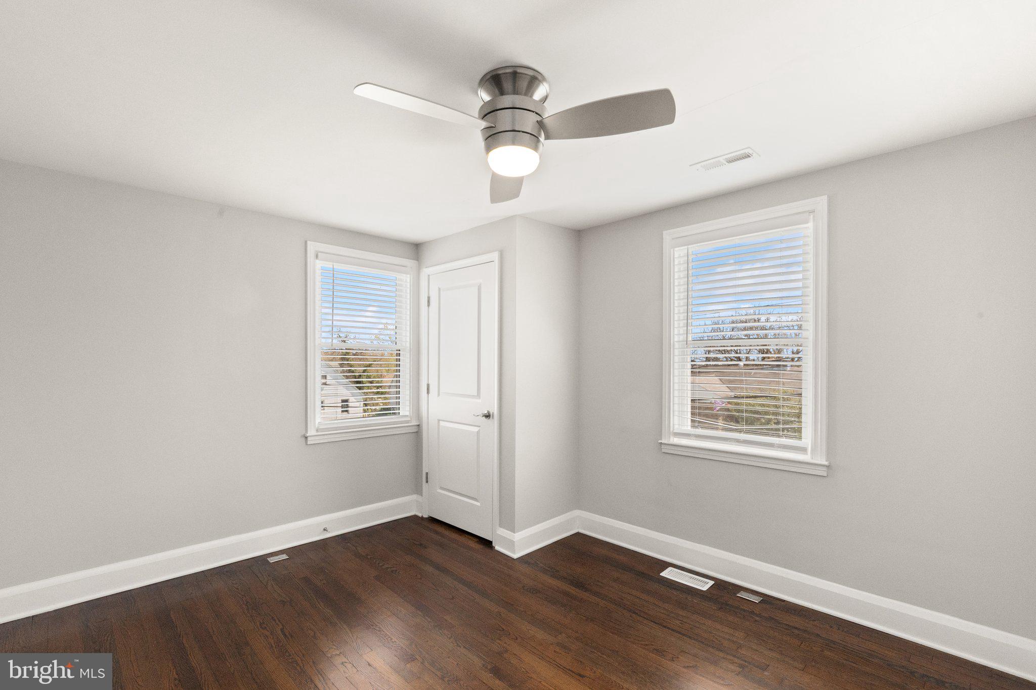 7512 Brightside Avenue Baltimore, MD 21237 - Photo 16 of 32 a view of an empty room with wooden floor and a window