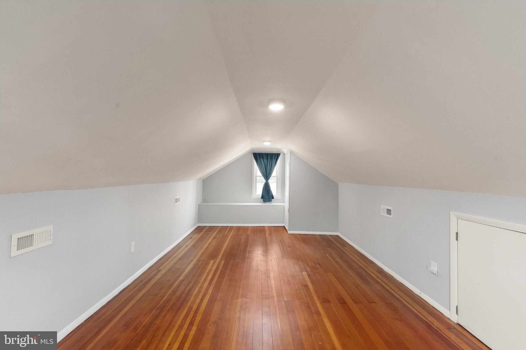 7512 Brightside Avenue Baltimore, MD 21237 - Photo 19 of 32 wooden floor in an empty room with a window