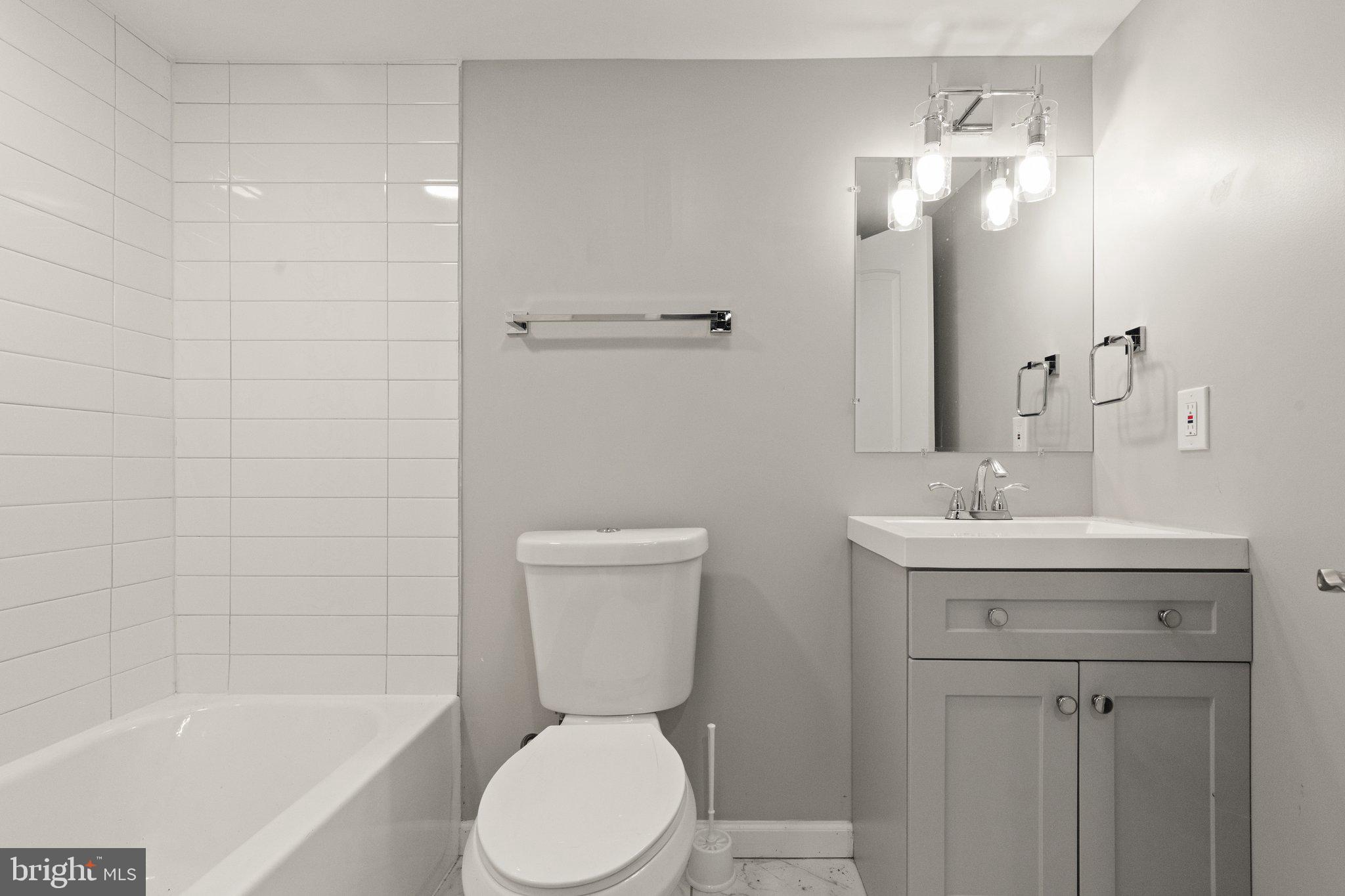 7512 Brightside Avenue Baltimore, MD 21237 - Photo 24 of 32 a bathroom with a sink a toilet and shower